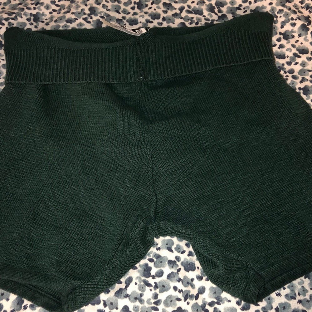 Knit green shorts.